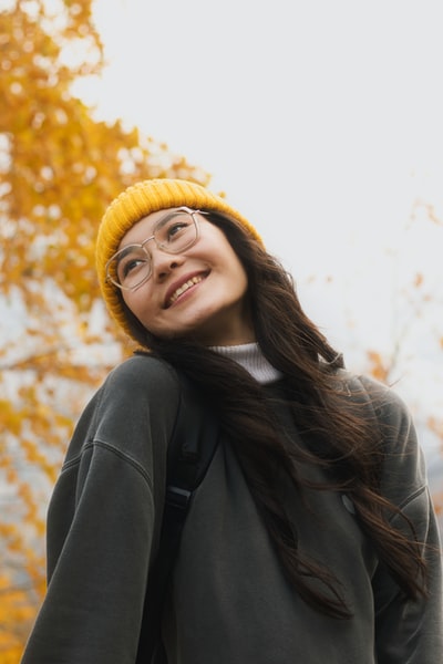 戴着黄色针织帽和黑色夹克的女人